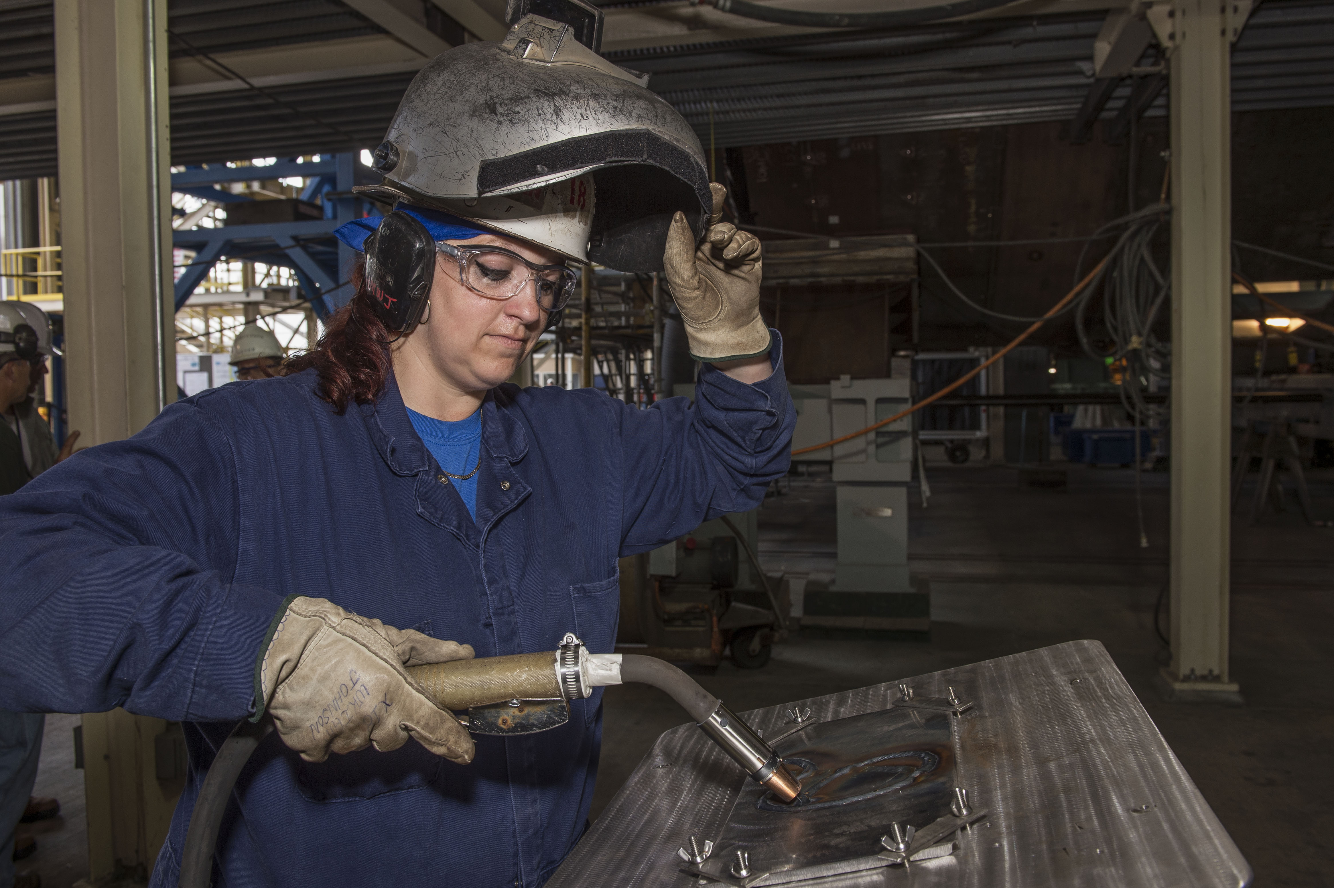 Heather Johnson welder for Indiana Keel Laying. Heather is the first female welder to weld the initals of a ships's sponsor on a Virginia-class submarine.