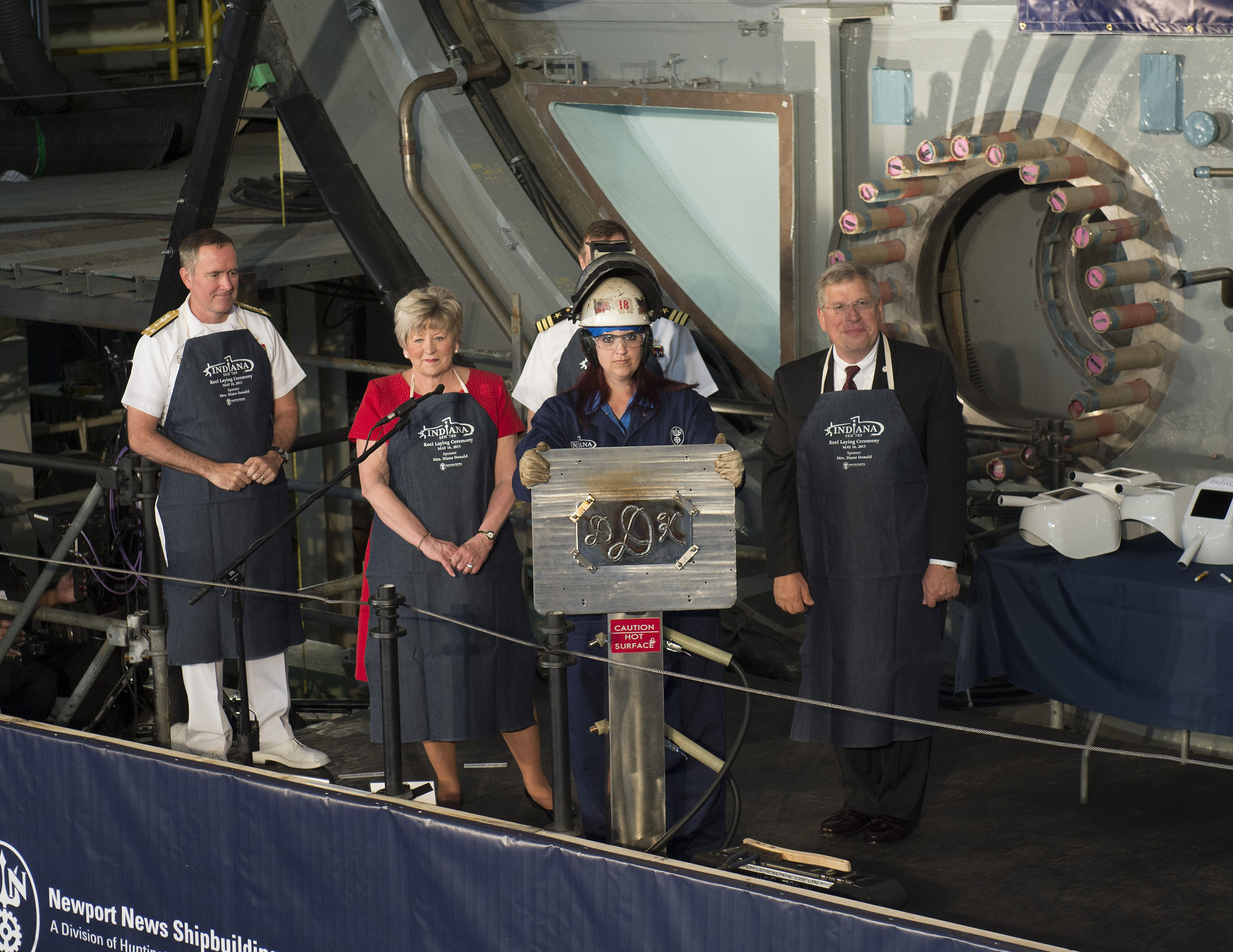 Heather Johnson shows ship's sponsor Diane Donald initials during a keel laying ceremony for the future Virginia-class attack submarine Indiana (SSN 789).